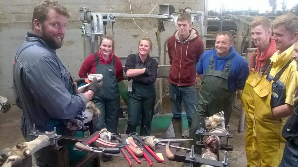 Image of Neil demonstrates hoof trimming techniques to the group in Cornwall